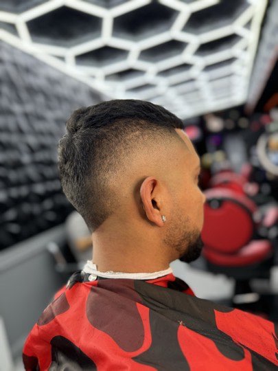 Burst fade with a shaved line that follows the curve of the ear.
