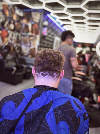 Heart shaved by hand on the nape over a fade.