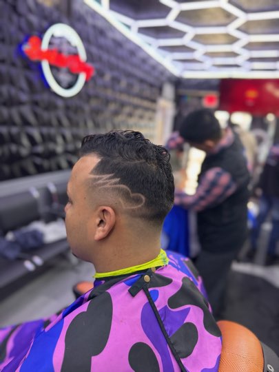 Curve shaved with a razor along the side over the fade.