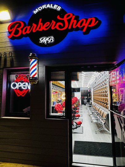 The entrance of Morales Barbershop MB, with the massage chair inside