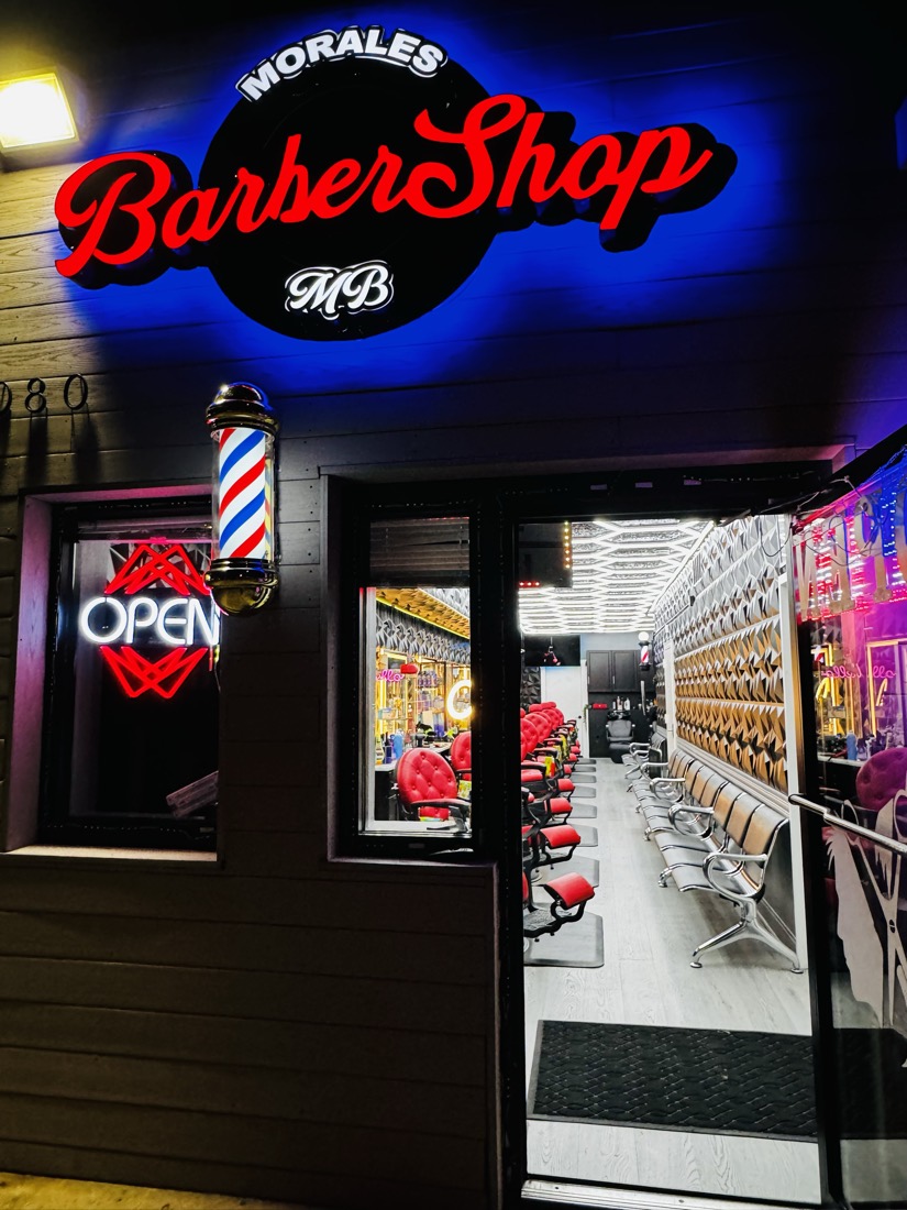 Entrance of Morales Barbershop MB at 2080 University Blvd E in Hyattsville, with the barber pole lit.