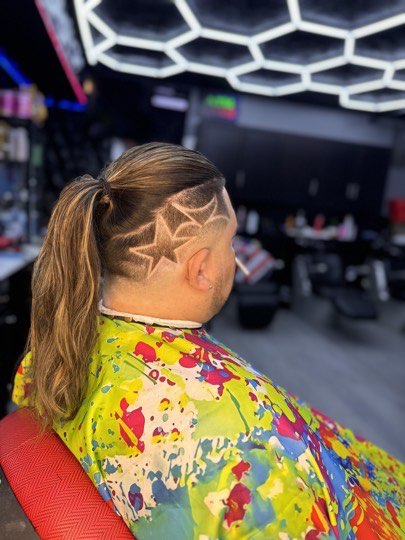 Stars shaved on the side with the hair pulled back in a ponytail.