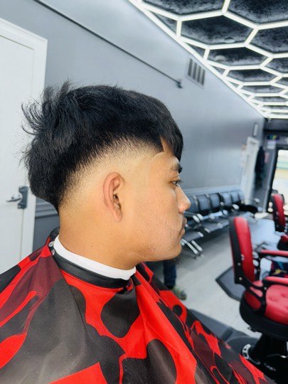 High fade with a long top styled up and textured.