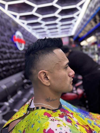 Mohawk with a high skin fade on both sides.