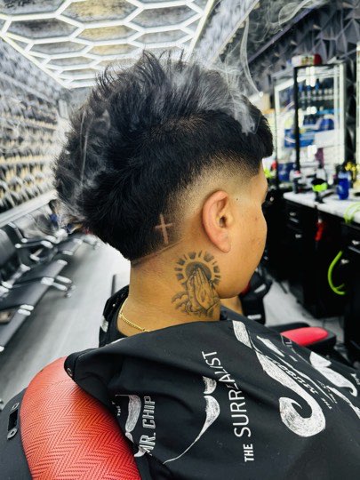 Mullet with volume on top and a fade around the ear.