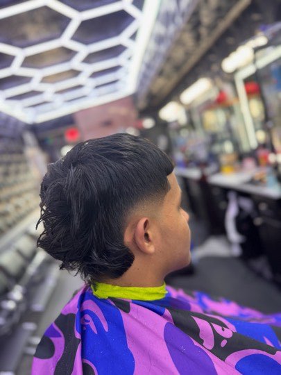 Wavy mullet with a taper on the sides, back view.