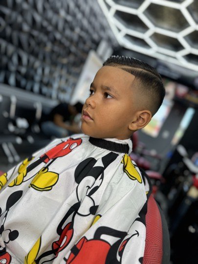 Kid with a high fade and a straight line up