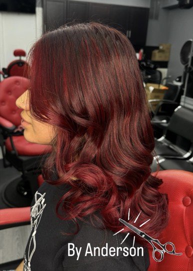 Defined waves done with a flat iron in deep red.