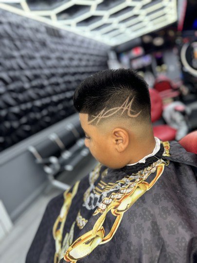 High skin fade with the client's initials shaved in by hand.