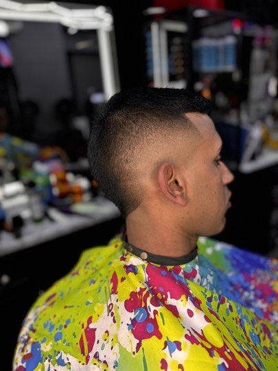High skin fade with the part shaved in with a razor and a flat top.