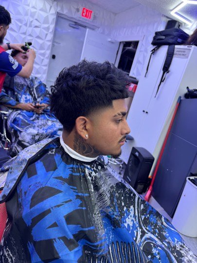 Perm curls with a mid fade on the sides