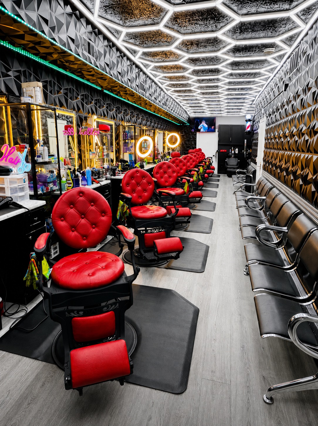 The shop at Morales Barbershop MB on University Boulevard, with barbers working and customers waiting
